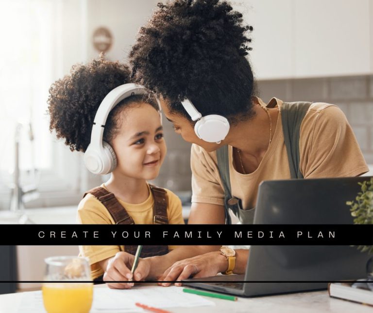 Mother and school-aged daughter in the kitchen working with a laptop with headphones on.