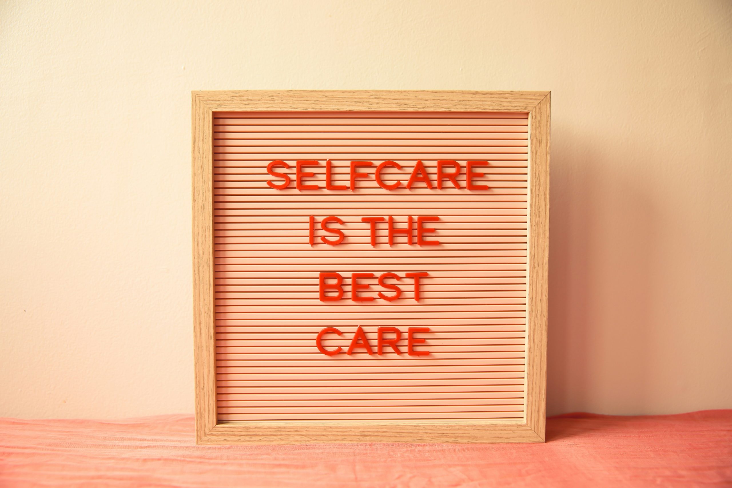 Letter board displaying the message "Self Care Is the Best Care," representing the importance of an after-work reset routine for working mom