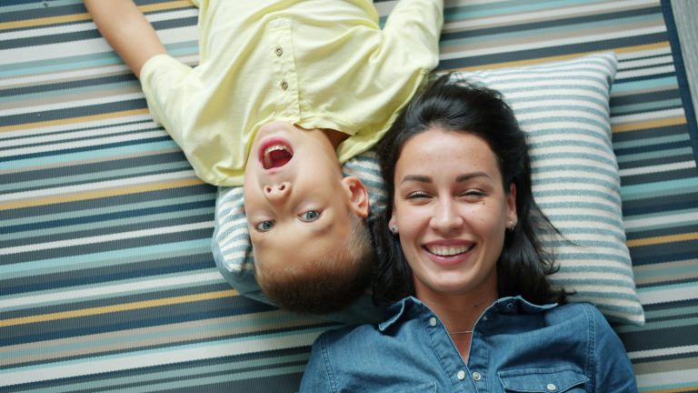 Mother and child relaxing together at home, illustrating how working moms can prioritize rest, self-care, and family while managing fatigue and daily responsibilities.