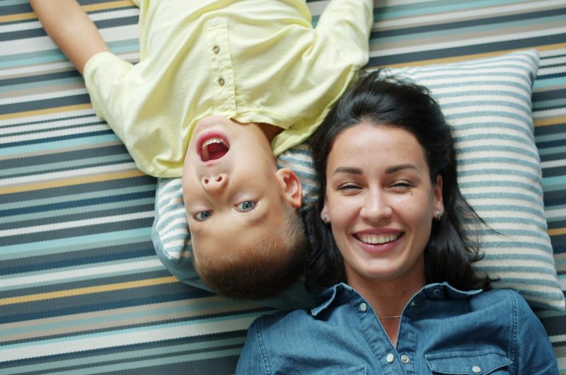 Mother and child relaxing together at home, illustrating how working moms can prioritize rest, self-care, and family while managing fatigue and daily responsibilities.