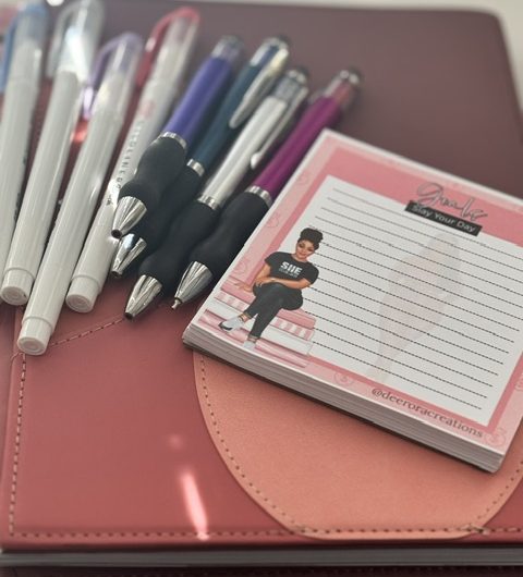 Paper planning setup with colorful pens and a notepad for writing tasks, reminders, and daily ideas.