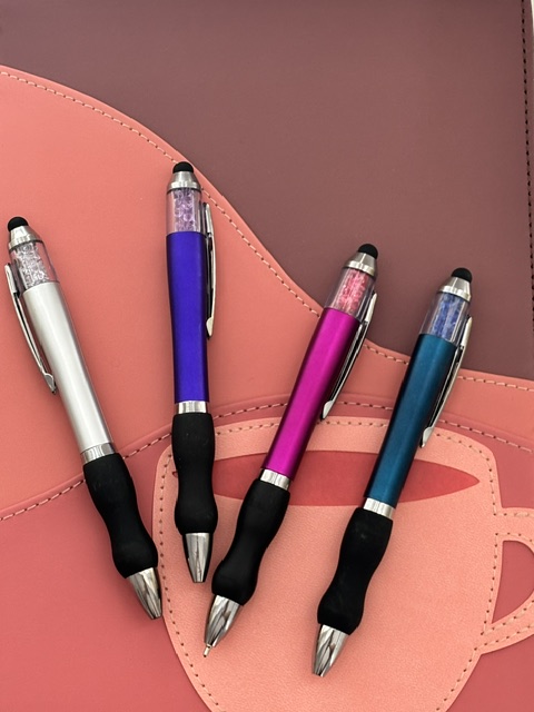 Colorful comfort grip pens for paper planning, journaling, and writing daily tasks in a planner.