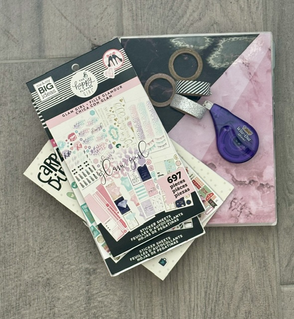 Planner sticker books, washi tape, and accessories used to decorate and organize a paper planner.